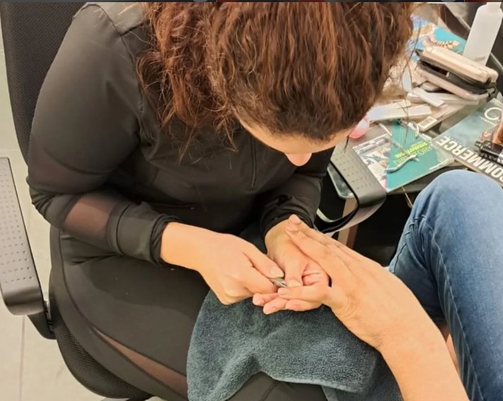Manicure in progress, cuticles being tidied